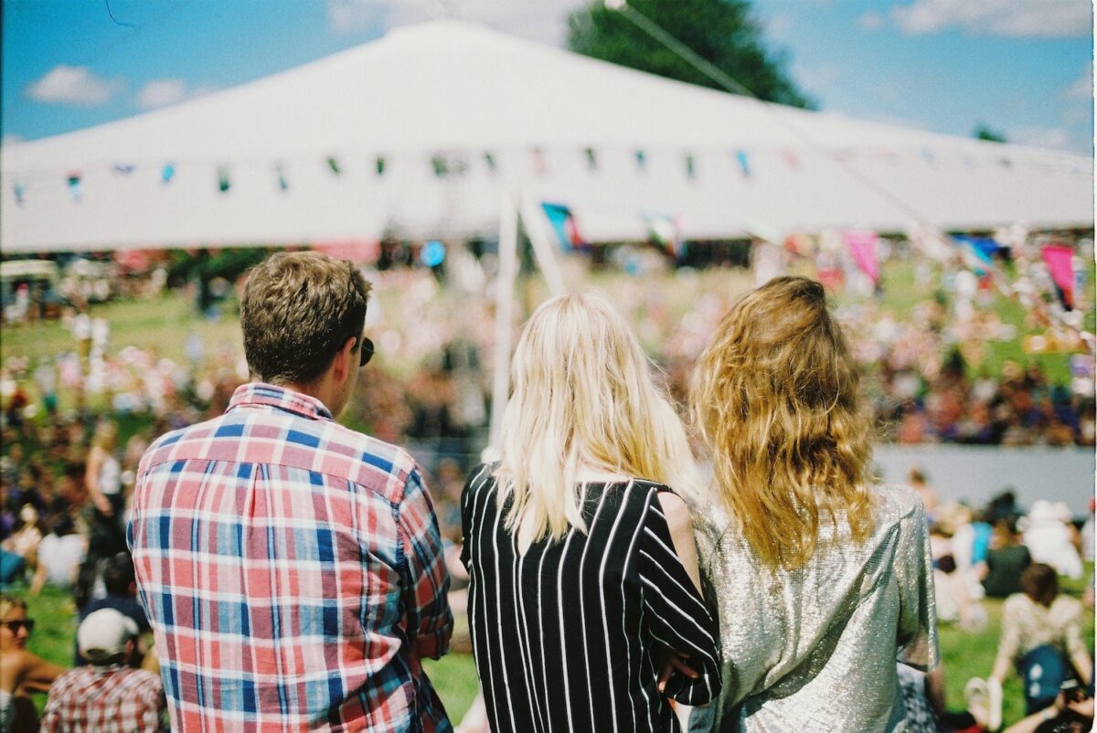 Three people enjoying an outdoor festival